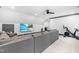 Spacious recreation room with a plush gray sectional couch, entertainment center, and an exercise bike at 10726 Trego Trl, Raleigh, NC 27614
