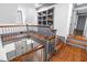 Open staircase boasts hardwood floors, gray trim and wainscoting, and built-in bookshelves at 10726 Trego Trl, Raleigh, NC 27614