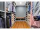 Spacious walk-in closet with custom shelves, drawers, and hardwood floors at 10726 Trego Trl, Raleigh, NC 27614