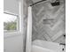 Modern bathroom featuring stylish tile work, a bathtub, and a rainfall shower head fixture at 1105 Massey St, Smithfield, NC 27577