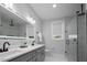 This bathroom features double sinks, a large mirror, and a glass walk-in shower with marbled walls at 1105 Massey St, Smithfield, NC 27577