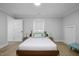 A bedroom with a large bed, a window, an accent chair, and a light wood floor at 1105 Massey St, Smithfield, NC 27577