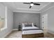 This bedroom offers a tray ceiling with a fan, a modern accent wall, and a neutral color palette at 1105 Massey St, Smithfield, NC 27577