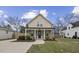 Charming two-story home with green siding, a covered porch, and a well-manicured lawn at 1105 Massey St, Smithfield, NC 27577