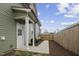 The side entrance features white columns, a white door, and a concrete walkway, bordered by a wood fence at 1105 Massey St, Smithfield, NC 27577