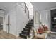 A staircase with iron railings leads to the second floor; a sitting area is nearby at 1105 Massey St, Smithfield, NC 27577