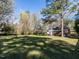 Lush backyard and lawn with mature trees, providing privacy and shade at 1106 Northview St, Garner, NC 27529