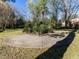 Grassy backyard with a round concrete patio and greenery landscaping at 1106 Northview St, Garner, NC 27529