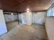 Unfinished basement with painted walls, concrete floors and limited natural light from a small window at 1106 Northview St, Garner, NC 27529