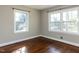 Bedroom featuring hardwood floors and natural light streaming in from multiple windows at 1106 Northview St, Garner, NC 27529