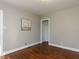 Neutral bedroom with polished wood floors, a sailboat painting, and closet at 1106 Northview St, Garner, NC 27529