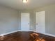 Cozy bedroom featuring hardwood floors and two bright white doors at 1106 Northview St, Garner, NC 27529