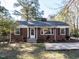 Inviting brick home with black shutters, manicured landscaping, and a welcoming front entrance at 1106 Northview St, Garner, NC 27529