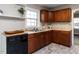 A view of the cozy kitchen showcasing wood cabinets and a black dishwasher at 1106 Northview St, Garner, NC 27529