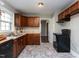 Cozy kitchen featuring wood cabinets, neutral countertops, and modern black appliances at 1106 Northview St, Garner, NC 27529
