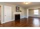 Bright living room with hardwood floors, a decorative fireplace, and an open layout at 1106 Northview St, Garner, NC 27529