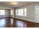 Bright living room with hardwood floors, large windows, and neutral paint at 1106 Northview St, Garner, NC 27529