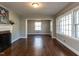 Spacious living room with hardwood floors, a fireplace, and large windows for natural light at 1106 Northview St, Garner, NC 27529