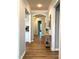 Inviting hallway with hardwood floors, neutral paint, crown molding and arched doorways, leading to other rooms at 1108 Mendocino St, Wake Forest, NC 27587