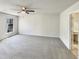 Spacious bedroom with neutral carpet and a ceiling fan, offering a serene retreat at 120 Chattleton Ct, Durham, NC 27712