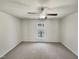 Spacious bedroom with plush carpet and a large window providing natural light at 120 Chattleton Ct, Durham, NC 27712