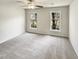 Bright bedroom with plush carpet and two windows providing natural light at 120 Chattleton Ct, Durham, NC 27712