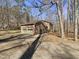 The exterior of this home features a two car garage with an extended driveway and mature landscaping at 120 Chattleton Ct, Durham, NC 27712