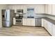 Modern kitchen with stainless steel appliances, white cabinets, and ample counter space at 120 Chattleton Ct, Durham, NC 27712