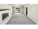 Open living room with a fireplace, large windows and sliding glass door access to the back deck at 120 Chattleton Ct, Durham, NC 27712