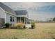 Well-maintained backyard featuring a lush lawn and landscaping that extends from the home's screened porch at 129 Edgefield Dr, Sanford, NC 27332