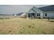 Expansive backyard with a screened porch, landscaping, and a well-maintained lawn that enhances outdoor living at 129 Edgefield Dr, Sanford, NC 27332