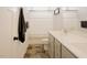 A well-lit bathroom showcasing a double sink vanity and a shower behind a patterned curtain at 129 Edgefield Dr, Sanford, NC 27332