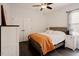 Comfortable bedroom showcasing hardwood floors, a ceiling fan, and natural light from the window at 129 Edgefield Dr, Sanford, NC 27332
