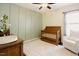 A charming Bedroom with green millwork, a wooden crib, and a glider for a peaceful space at 129 Edgefield Dr, Sanford, NC 27332