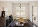 Bright dining area featuring a round table, four chairs, and an adjacent cabinet for storage and display at 129 Edgefield Dr, Sanford, NC 27332