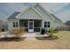 Beautiful home featuring a screened porch, well-kept lawn, and a patio perfect for outdoor gatherings at 129 Edgefield Dr, Sanford, NC 27332