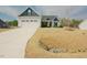 Beautiful home featuring a two-car garage, blue accents, and a well-maintained lawn at 129 Edgefield Dr, Sanford, NC 27332