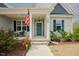 Inviting front porch with an American flag and pleasant landscaping at 129 Edgefield Dr, Sanford, NC 27332
