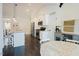 Open kitchen with white cabinets, stainless steel appliances, island seating, and pantry at 129 Edgefield Dr, Sanford, NC 27332