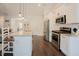 Modern kitchen with white cabinets, stainless steel appliances, and a spacious island with seating at 129 Edgefield Dr, Sanford, NC 27332