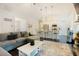 Open-concept living area with a sectional sofa, a kitchen with a breakfast bar, and bright lighting at 129 Edgefield Dr, Sanford, NC 27332