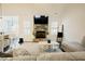 Cozy living room with a stone fireplace, a TV, and a comfortable sectional sofa at 129 Edgefield Dr, Sanford, NC 27332