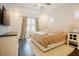 Inviting main bedroom with a tray ceiling, ceiling fan, large bed, and stylish furnishings at 129 Edgefield Dr, Sanford, NC 27332