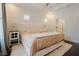 Bright main bedroom featuring tray ceiling, carpet, and access to ensuite bathroom at 129 Edgefield Dr, Sanford, NC 27332