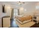 Inviting main bedroom with a tray ceiling, ceiling fan, large bed, and stylish furnishings at 129 Edgefield Dr, Sanford, NC 27332