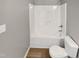 Small white bathroom with a tub and toilet at 13 Herndon Ct, Clayton, NC 27520