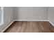 A vacant bedroom featuring hardwood floors, neutral walls, and a window at 13 Herndon Ct, Clayton, NC 27520