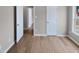 Empty bedroom features hardwood flooring, and an adjacent room behind an open door at 13 Herndon Ct, Clayton, NC 27520