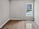 Bedroom featuring hardwood flooring, neutral walls, a large window, and natural light at 13 Herndon Ct, Clayton, NC 27520