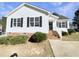 Charming single-story home with white siding, black shutters, and landscaped front yard at 13 Herndon Ct, Clayton, NC 27520